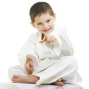 Little karate kid pointing forward